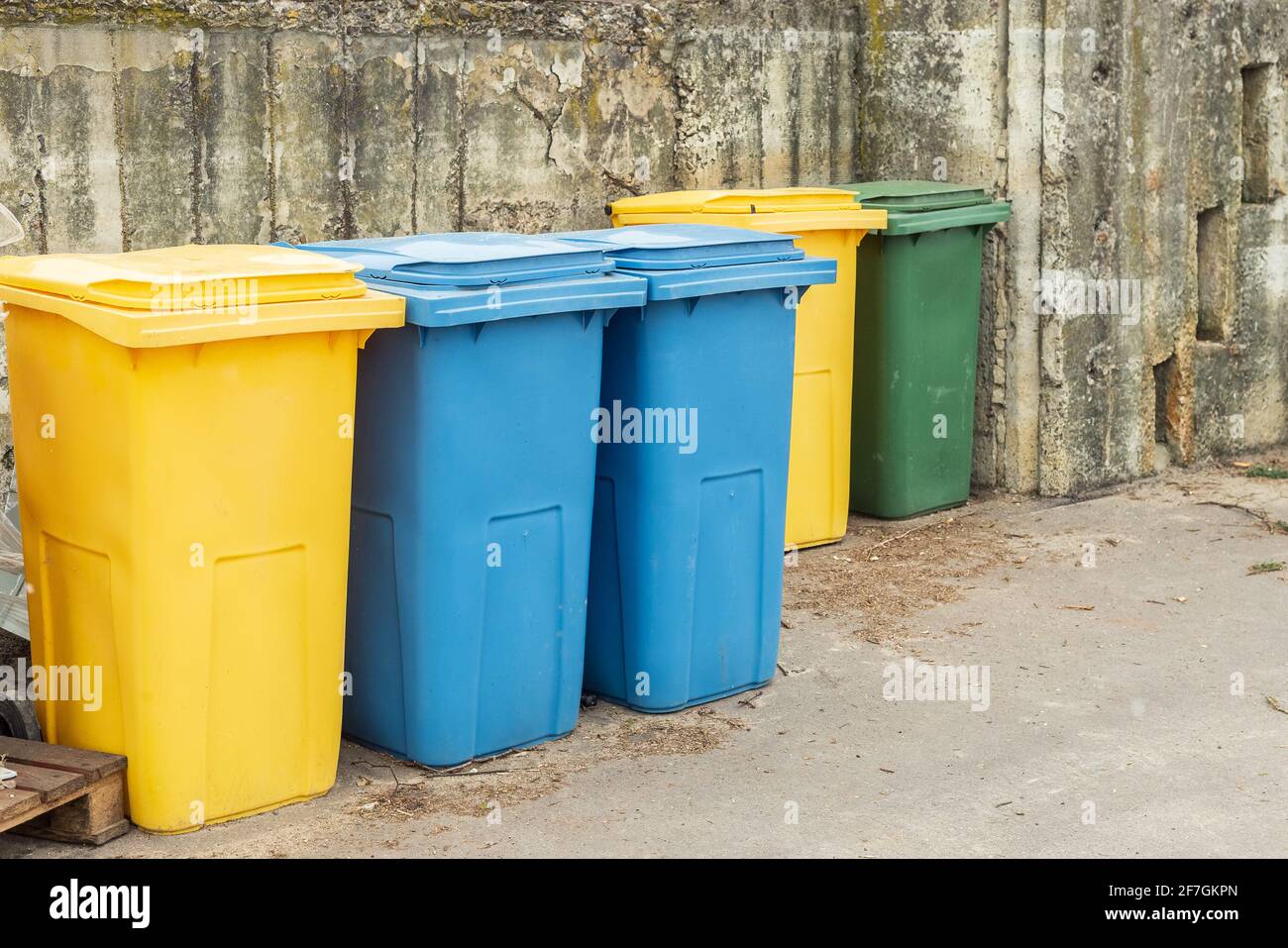 Blue and yellow trash cans or garbage bins outdoors Stock Photo Alamy