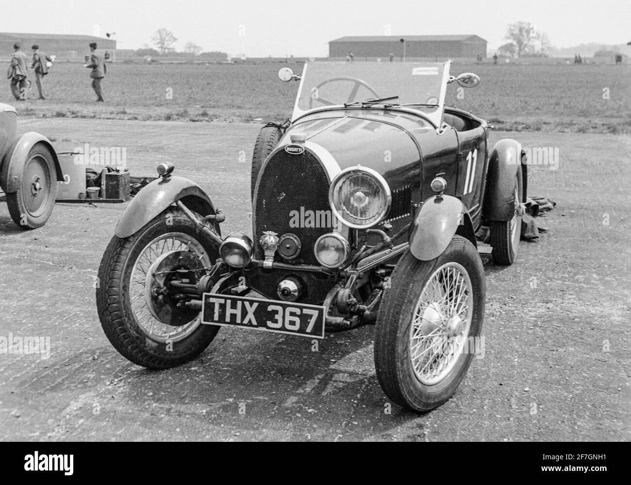 A vintage black and white photograph taken in 1950 at the Shelsley Walsh Hill Climb in England. A Bugatti Type 40 Grand Sport, registration number THX 367, racing number 11. Stock Photo
