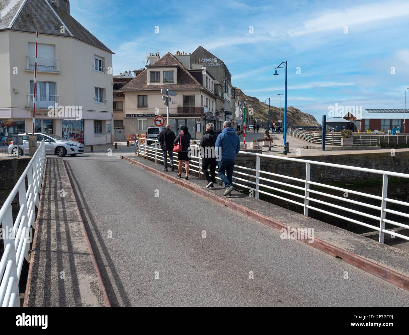 Port-en-Bessin-Huppain, France, March 2021. Tourists walking along the streets in a small town in Normandy - Port-en-Bessin. Stock Photo