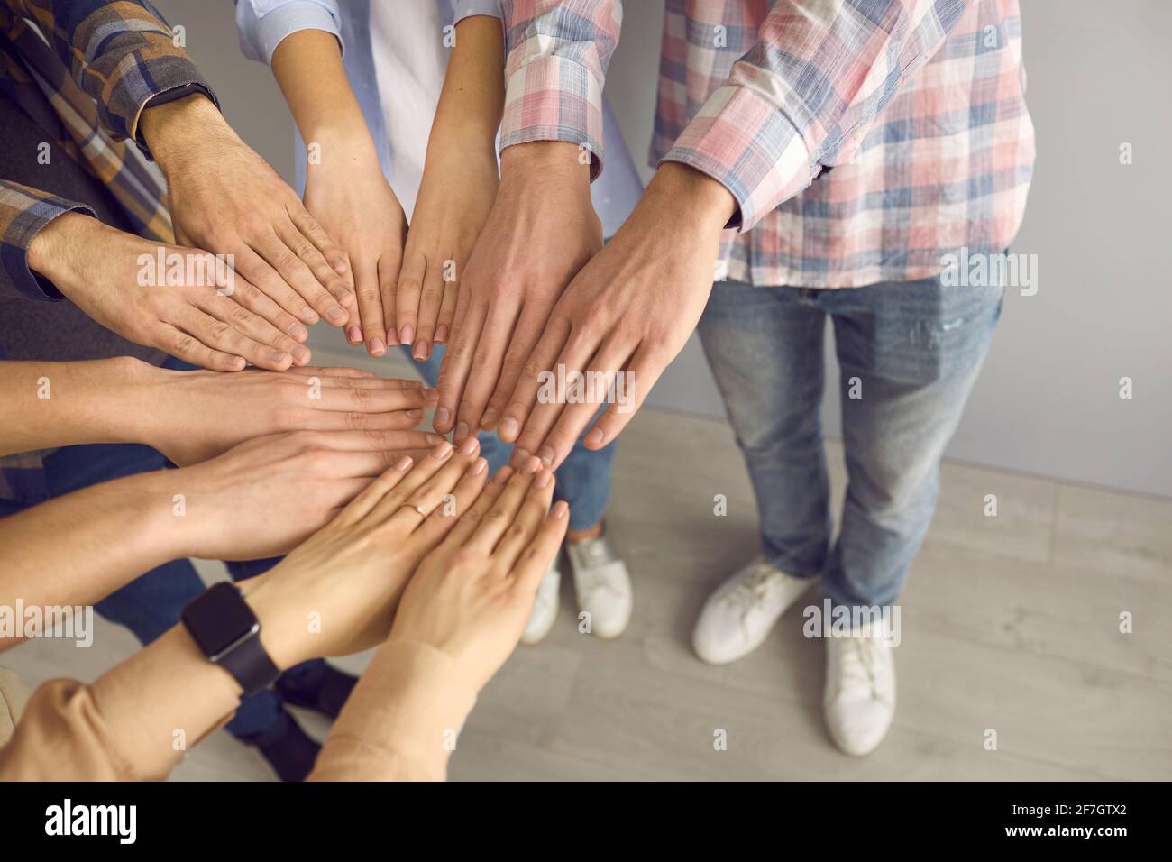 Closeup teenagers palm together in circle show team spirit shot with copy space Stock Photo