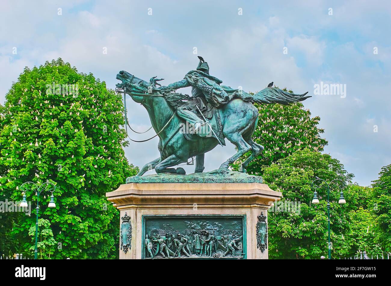 The scenic equestrian statue of Prince Ferdinand of Savoy, surrounded with blooming chestnut trees of Alfredo Frassati Garden, Piazza Solferino square Stock Photo