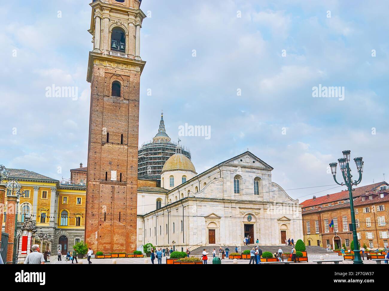 TURIN, ITALY - May 9, 2012: The facade of the St John the Baptist Cathedral (Duomo di Torino) with tall brick bell tower (Campanile), located in Piazz Stock Photo