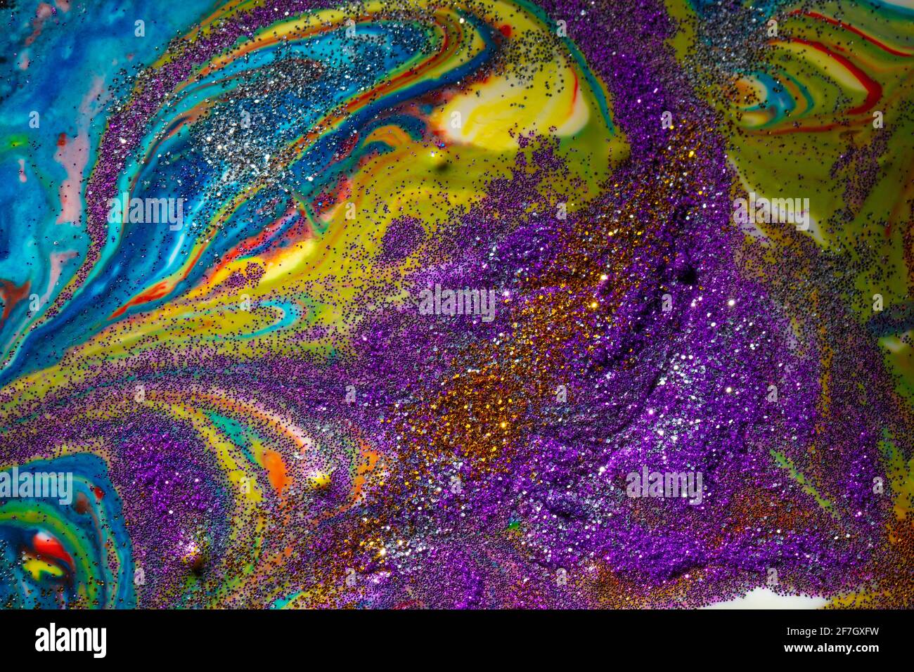 Multicolored acrylic background with curls sprinkled with purple and gold sparkles. Contemporary creativity. A colorful avant-garde painting with rich Stock Photo