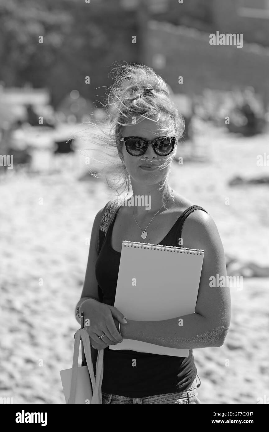 Beautiful female artist holding sketchbook outdoors. St Ives ,Cornwall ,England. Stock Photo