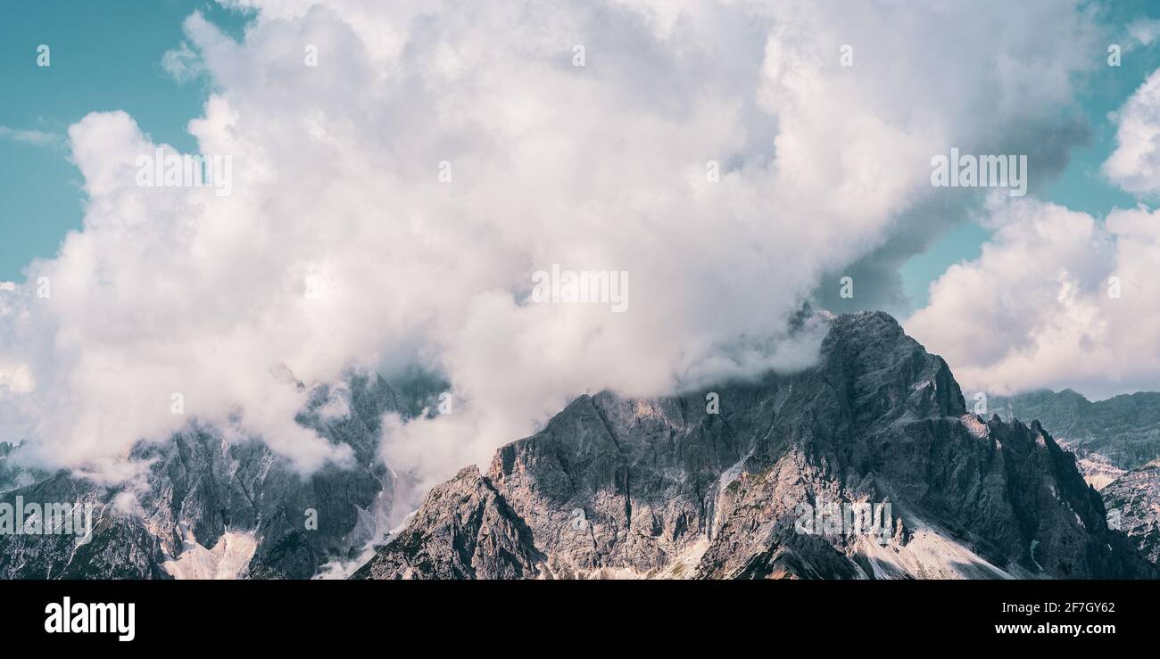 Clouds over mountain peaks in the Dolomites, Italy Stock Photo - Alamy