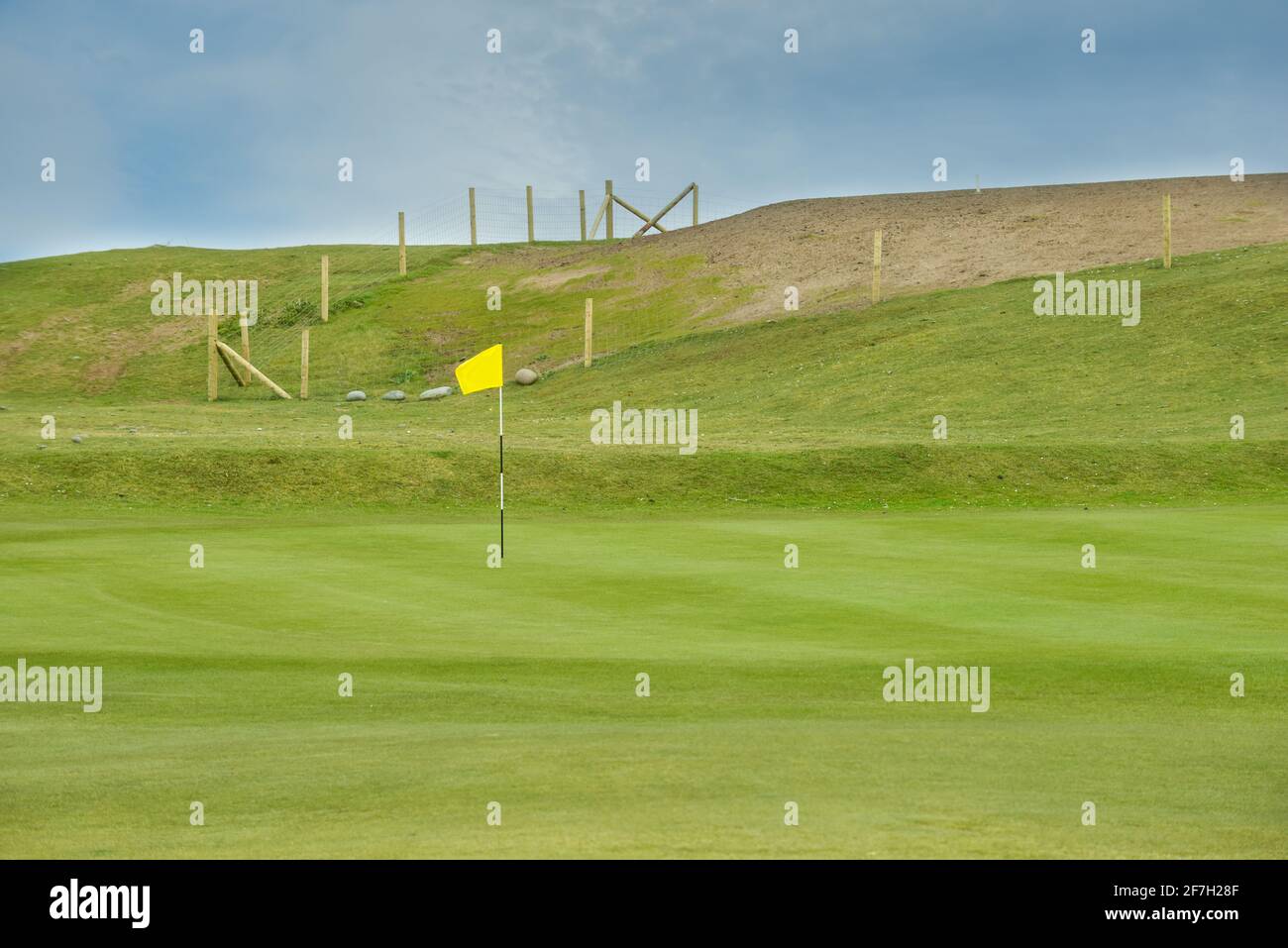 Golf course putting green with short grass and flag marking hole Stock ...