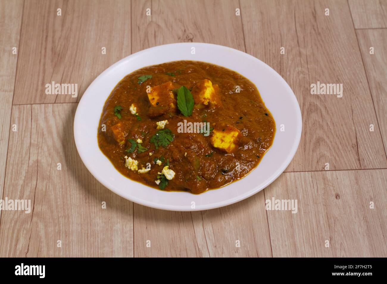 Amritsari Paneer, is a famous indian dish, served over a rustic wooden background, selective focus Stock Photo