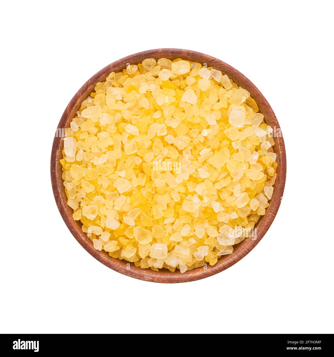 SPA concept. Yellow bath salt in a wooden bowl isolated over white background with a clipping path. Top view Stock Photo
