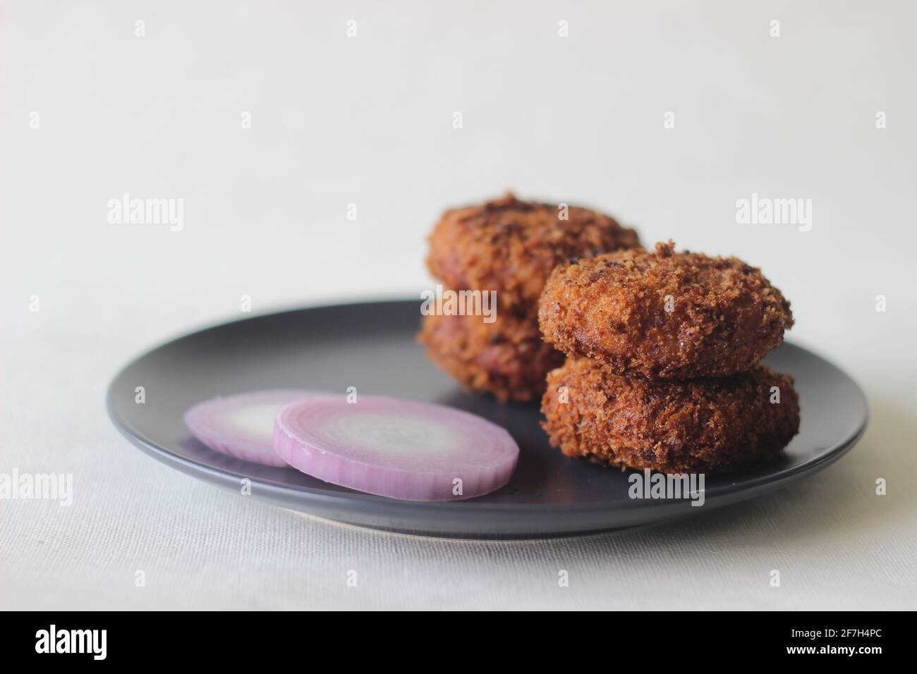 Dark brown color chicken cutlet. Deep fried evenly to get a crispy texture. Shot on white background Stock Photo