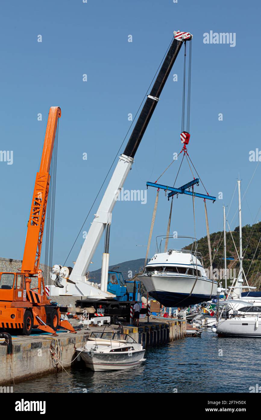 Boat launch operations with marina crane Stock Photo