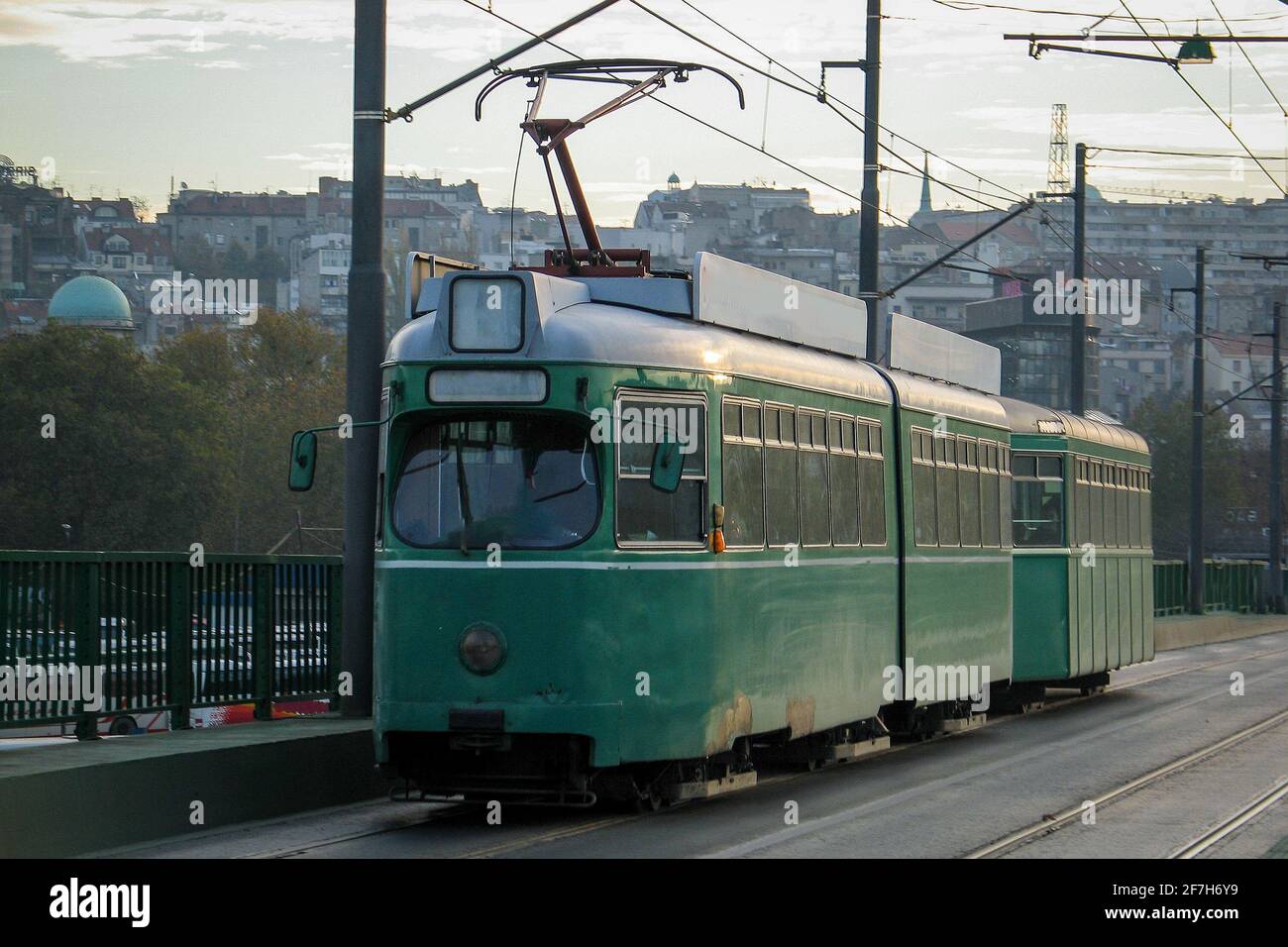 An old green tram in Belgrade is driving over the Stari savski most in ...