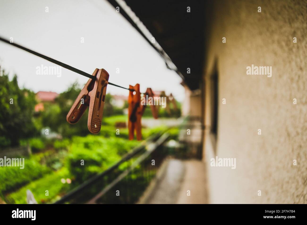 Detail of a peg for drying clothes. A line for drying clothes with pegs on the balcony in the suburban area of the city. Empty clothes washing line. Stock Photo