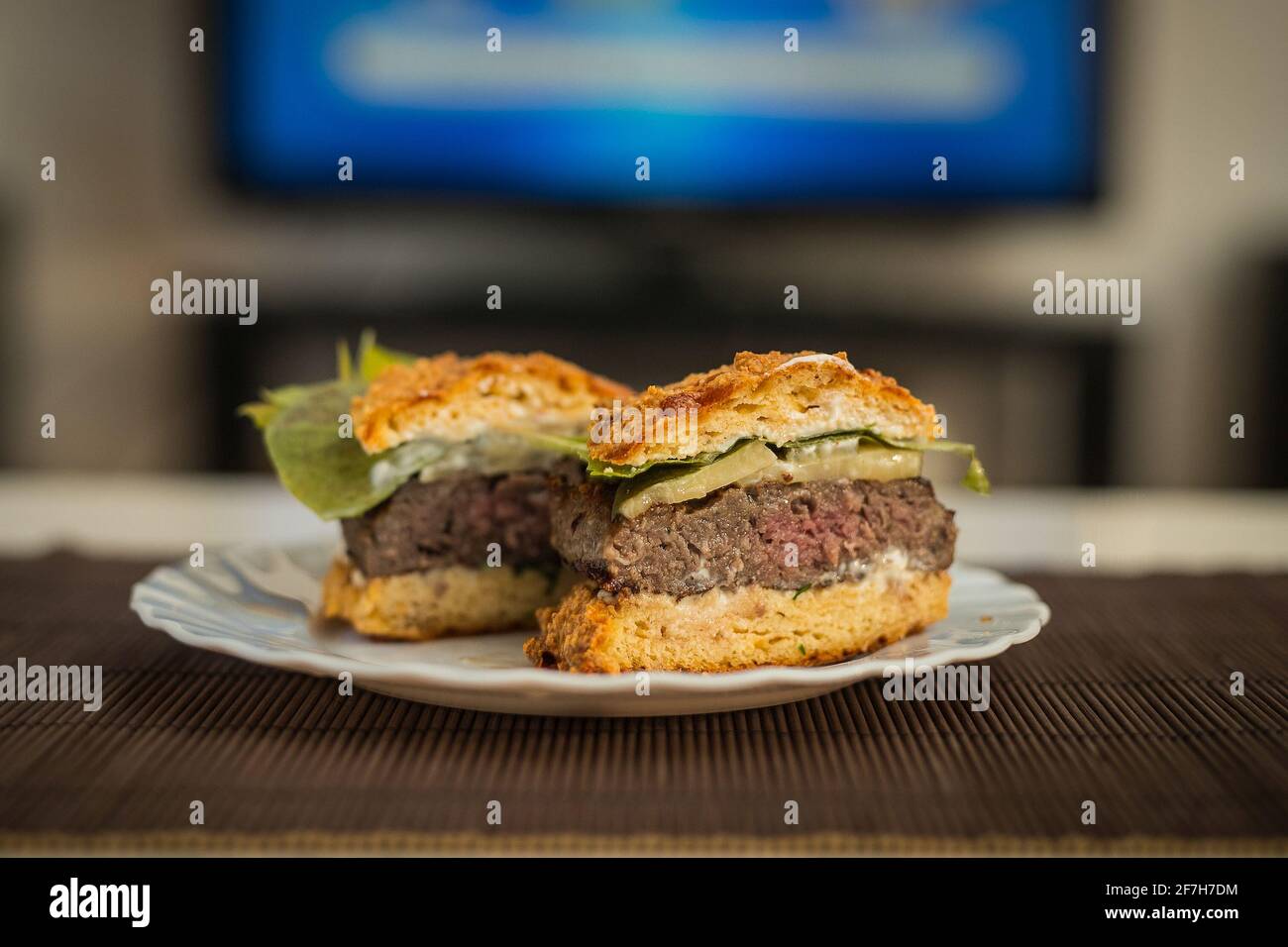 LCHF Low carbohydrate high fat burger or hamburger meal. LCHF burger with non carbohydrate bread made of sesame, eggs, chees, almonds. Concept picture Stock Photo