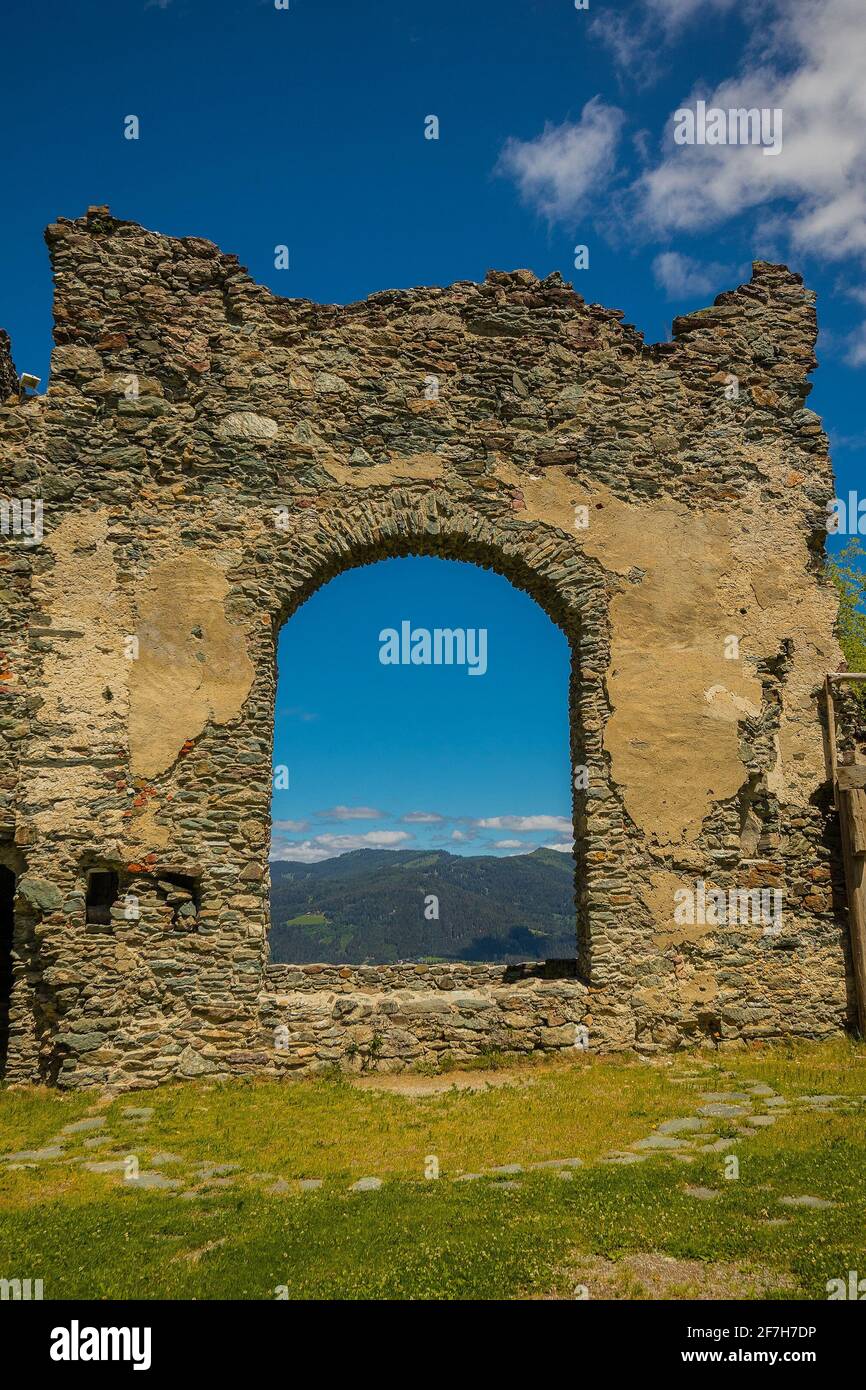 Inside of Steinschloss castle ruins rising above the mura valley in styria, Austria. Medieval ruins in Austria on a sunny day, look through one of the Stock Photo