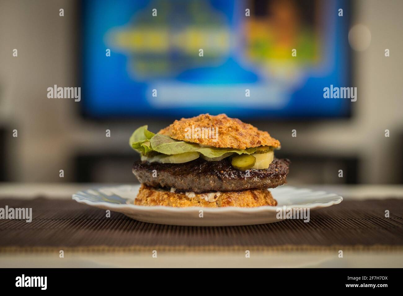 LCHF Low carbohydrate high fat burger or hamburger meal. LCHF burger with non carbohydrate bread made of sesame, eggs, chees, almonds. Concept picture Stock Photo