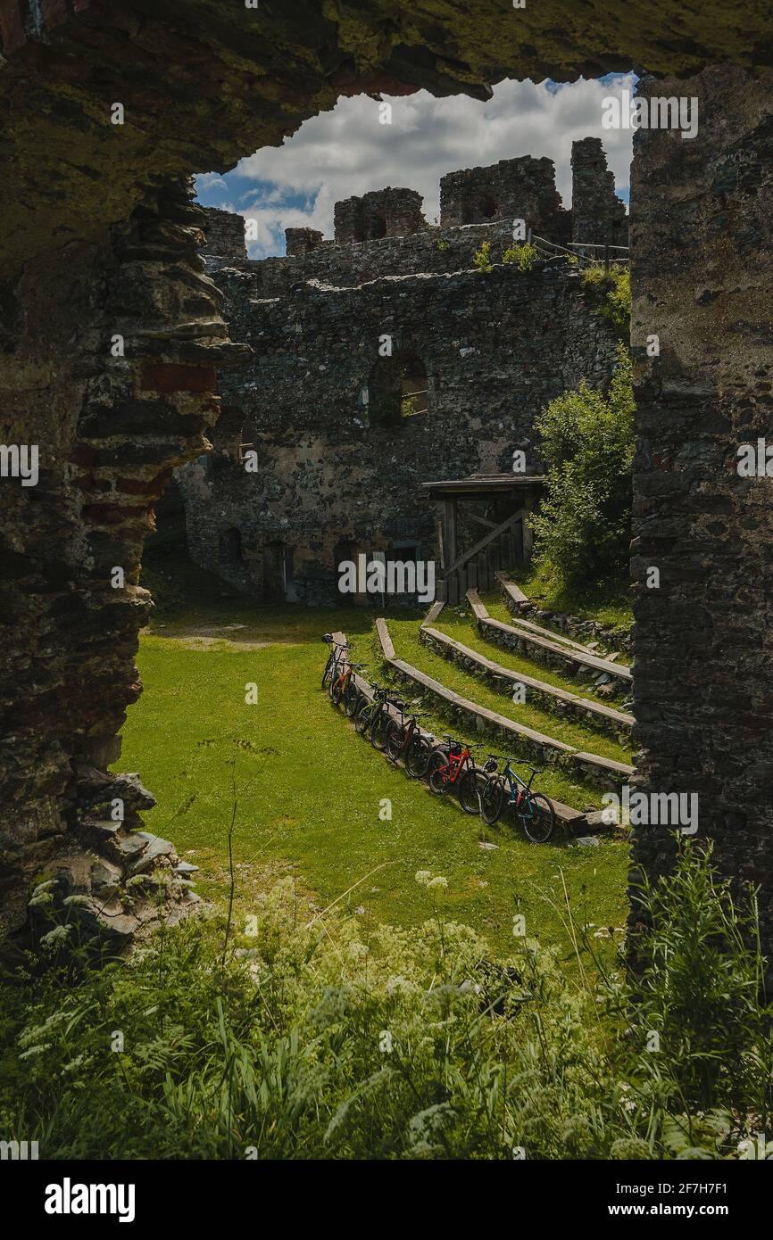 Inside of Steinschloss castle ruins rising above the mura valley in styria, Austria. Medieval ruins in Austria on a sunny day, bicycles are seen insid Stock Photo