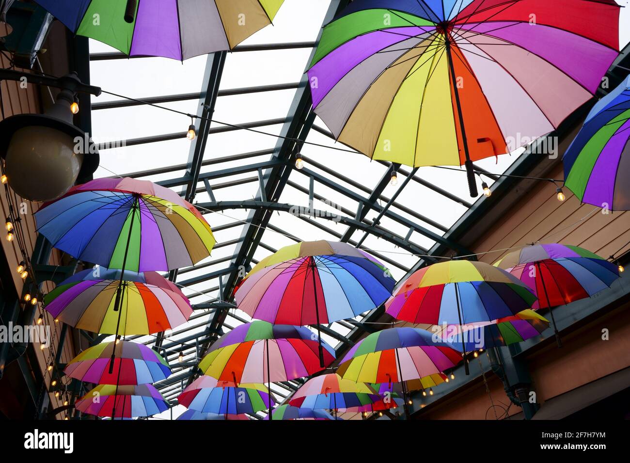 Bright umbrellas in covered sky-lighted mall Stock Photo