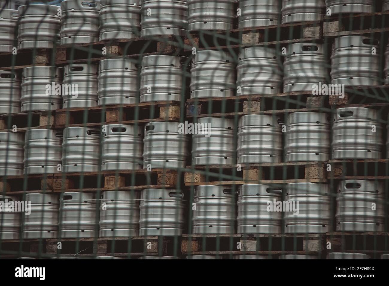 Large amount of aluminium beer kegs stacked on each other with euro