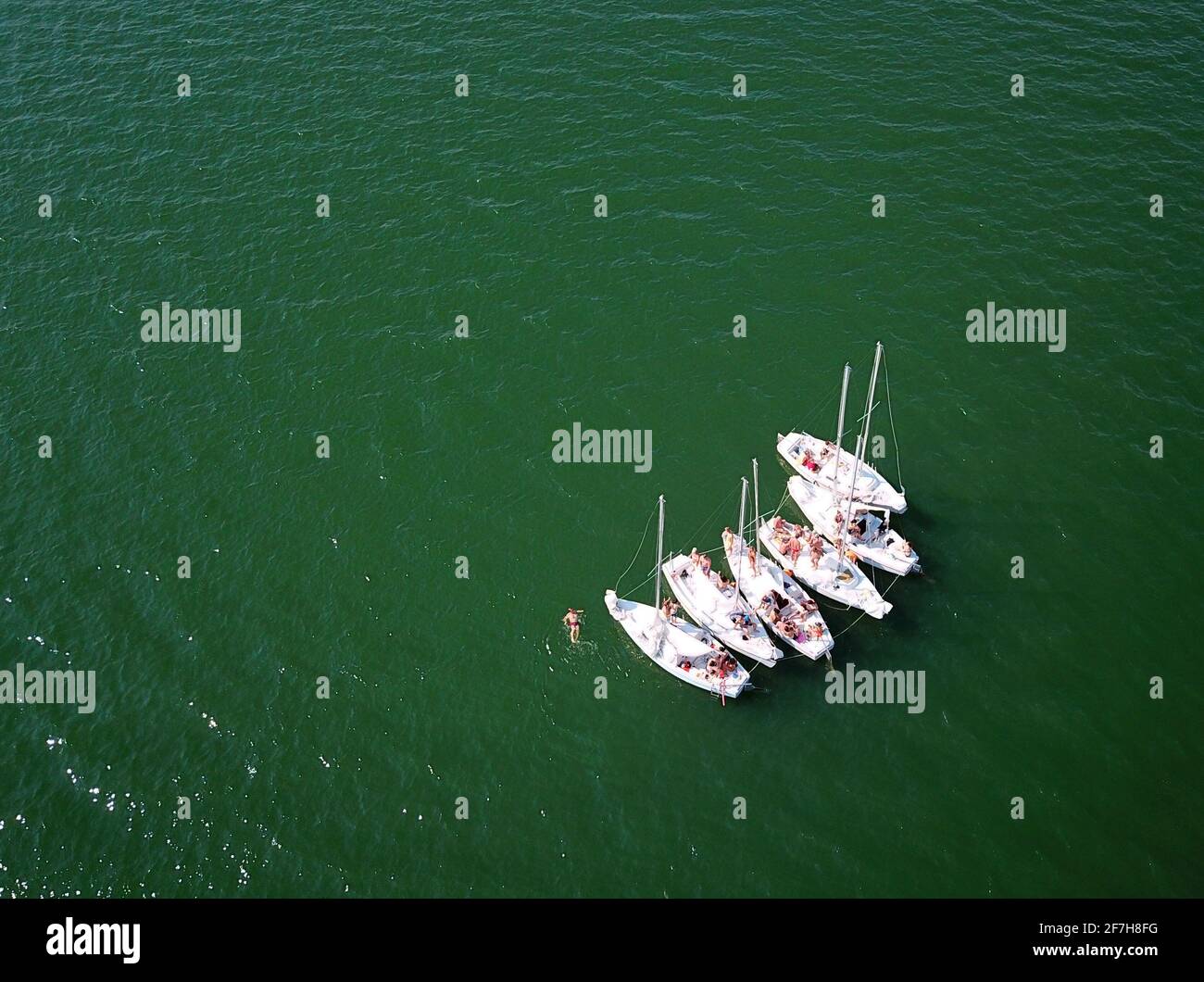 Six small sailing boats tied together for an 'on-lake-party' Stock Photo