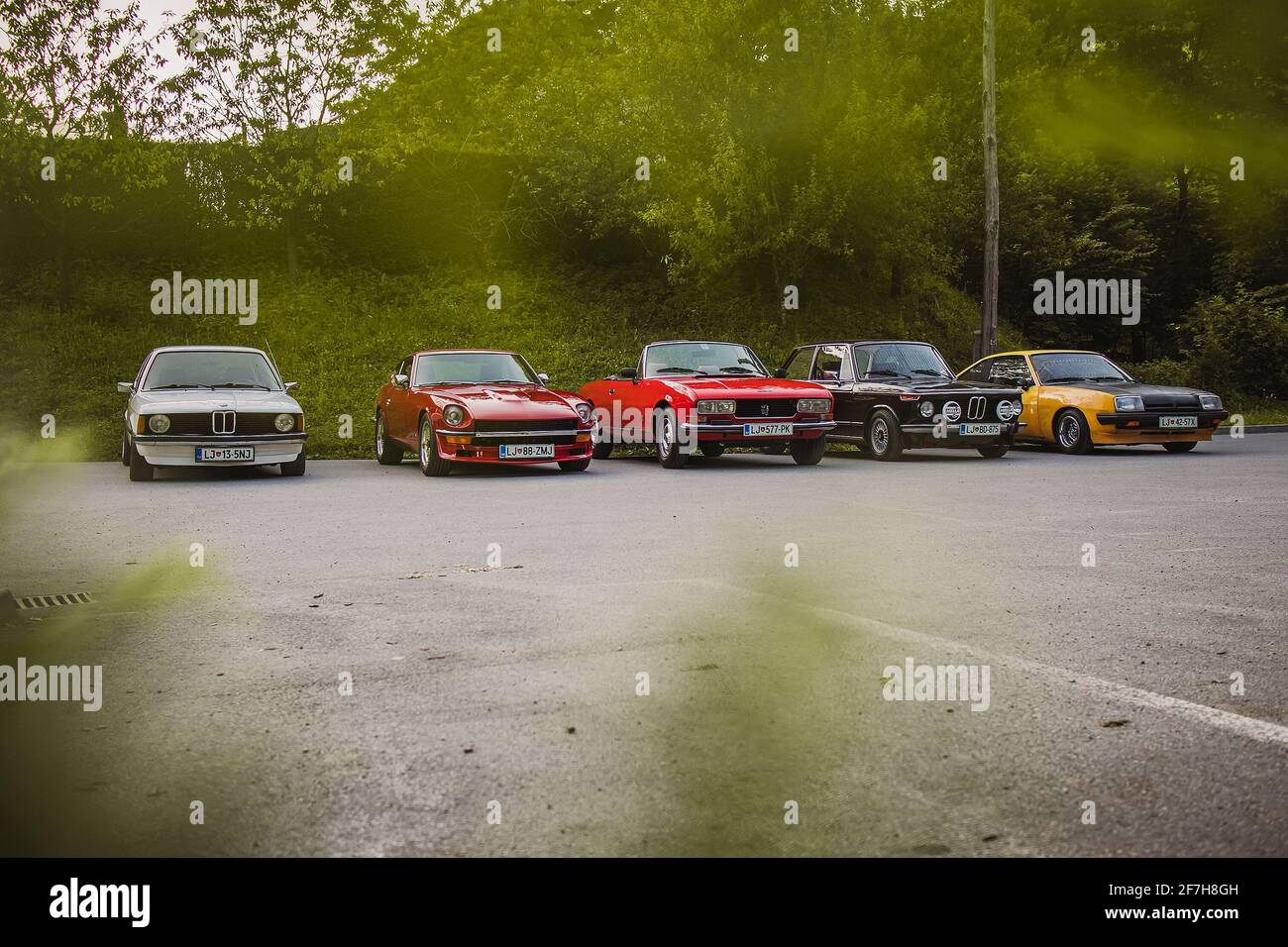 Polhov Gradec, Slovenia, 25.6.2019: A group of old vintage cars, including Datsun 240Z, Opel Manta B, Peugeot 504 and Bmw E21 325 and 2002 tii, waitin Stock Photo