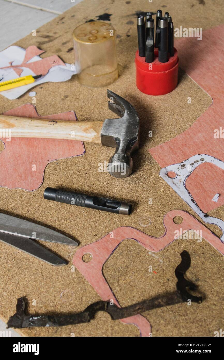 Making a new paper gasket for hobby automotive program. Visible centre punch, scissors, material