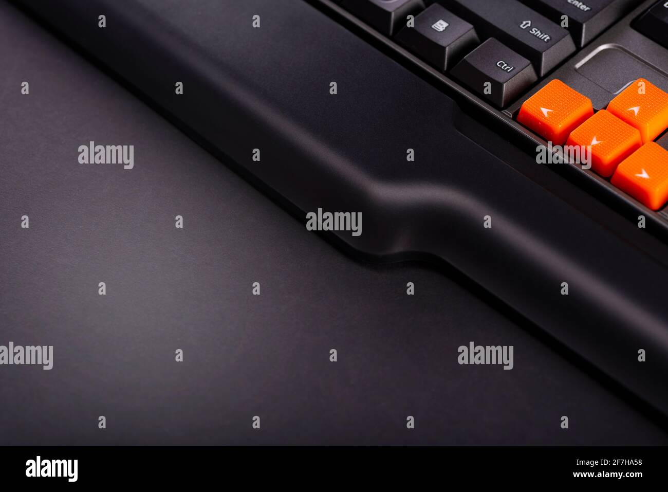 Orange arrow keys on a black keyboard, up, down, left, right buttons on ...