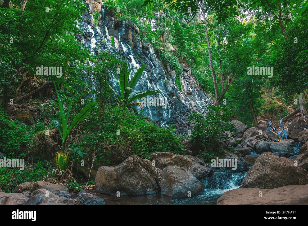 Mexico, Valle de Bravo, Panoramic view of the beautiful natural waterfall 'Velo de Novia' surrounded by vegetation and large stones Stock Photo