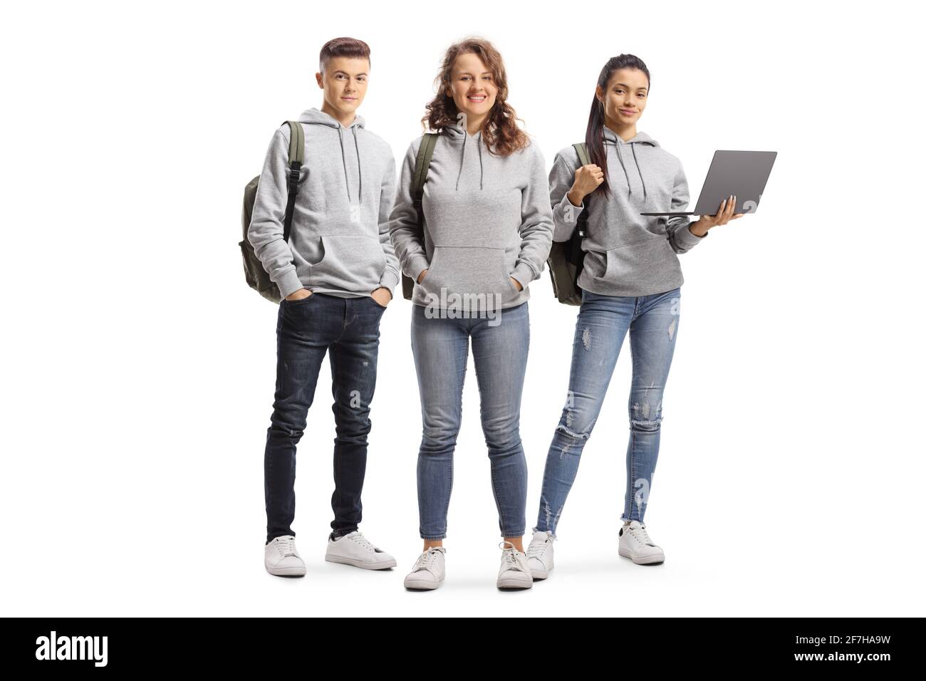 College students with backpacks and a laptop isolated on white background Stock Photo