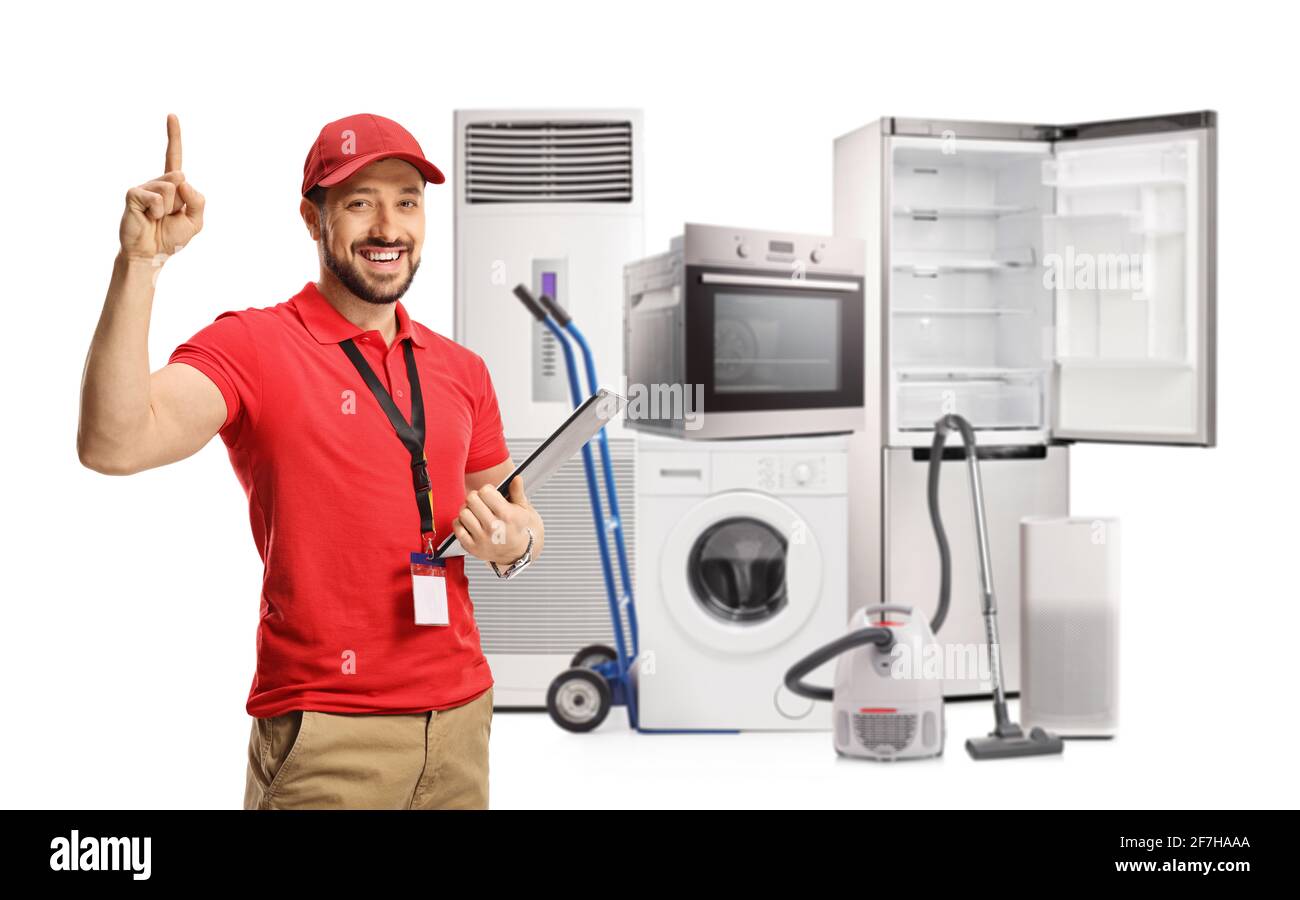 Male shop assistant with electircal home appliances pointing up isolated on white background Stock Photo