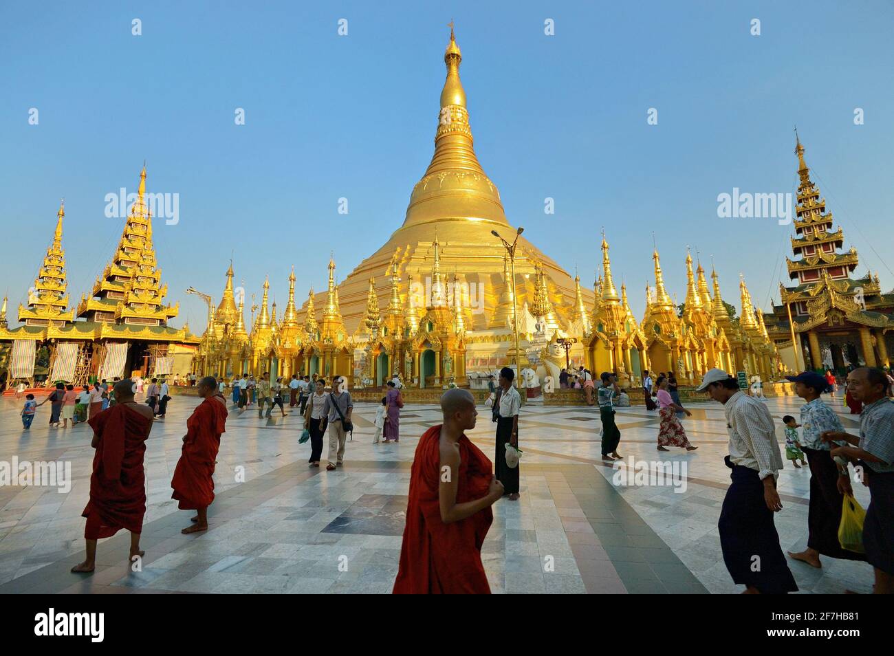 Monks and visitors at Shwedagon Pagoda, Yangon, Myanmar Stock Photo