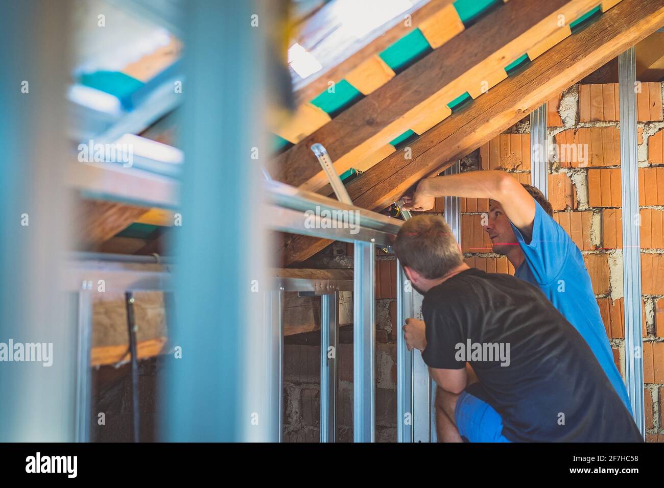 Drywall plaster wall metal fixation. A person holding and mounting