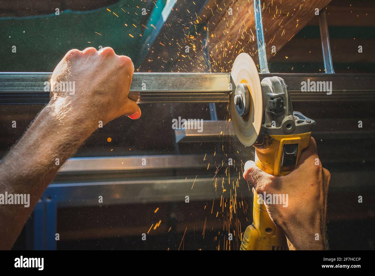 Photo of a person cutting holders, aluminium profiles or aluminium