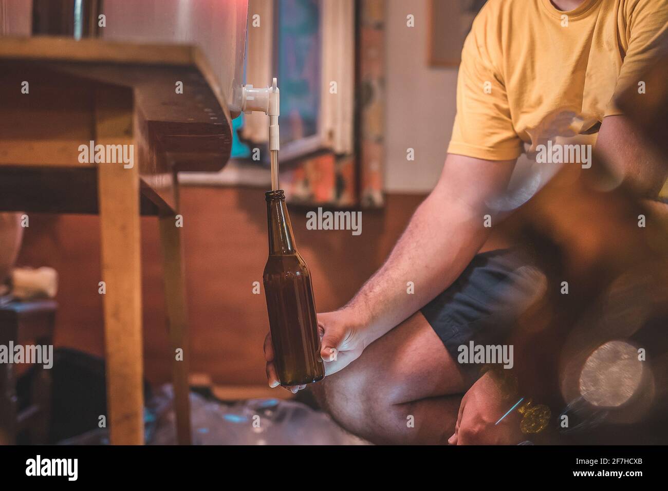 Home craft beer brewery. Final step of pouring a fresh IPA beer into a