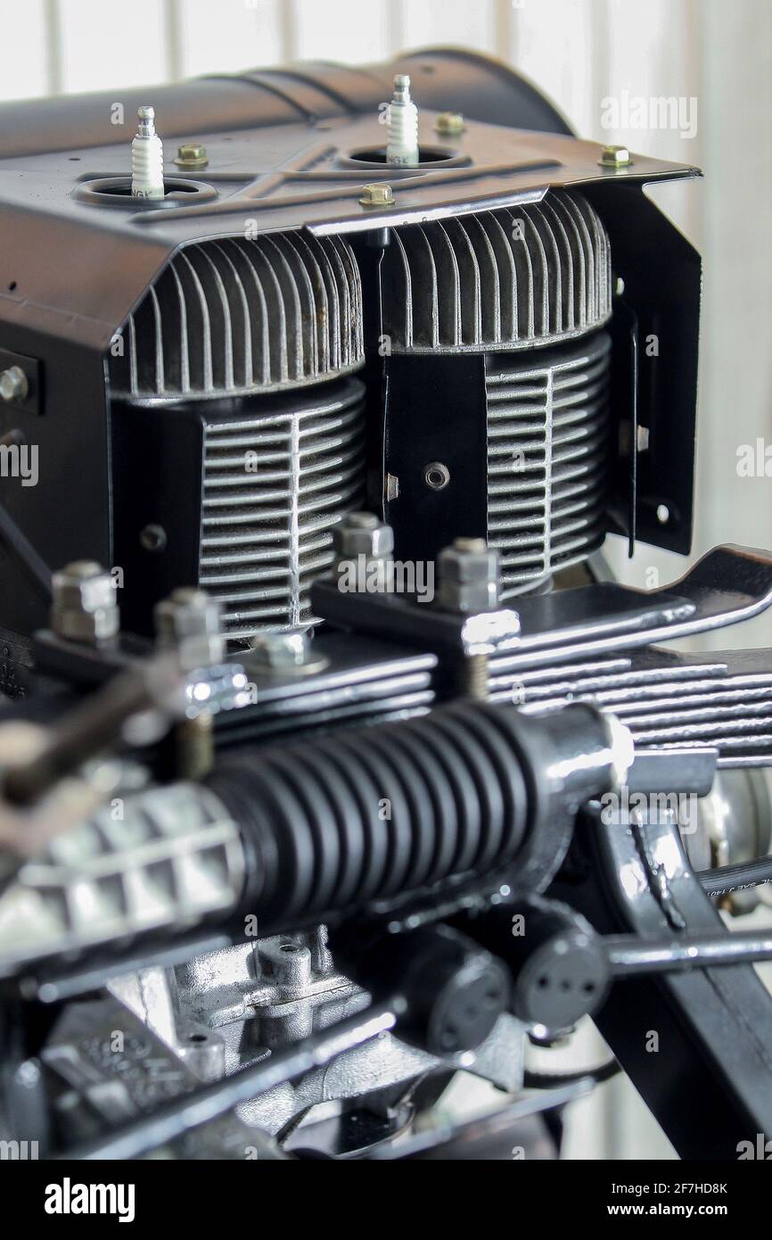 Clean cooling fins and cylinders of an old two stroke car engine with sparkplugs visible. Stock Photo