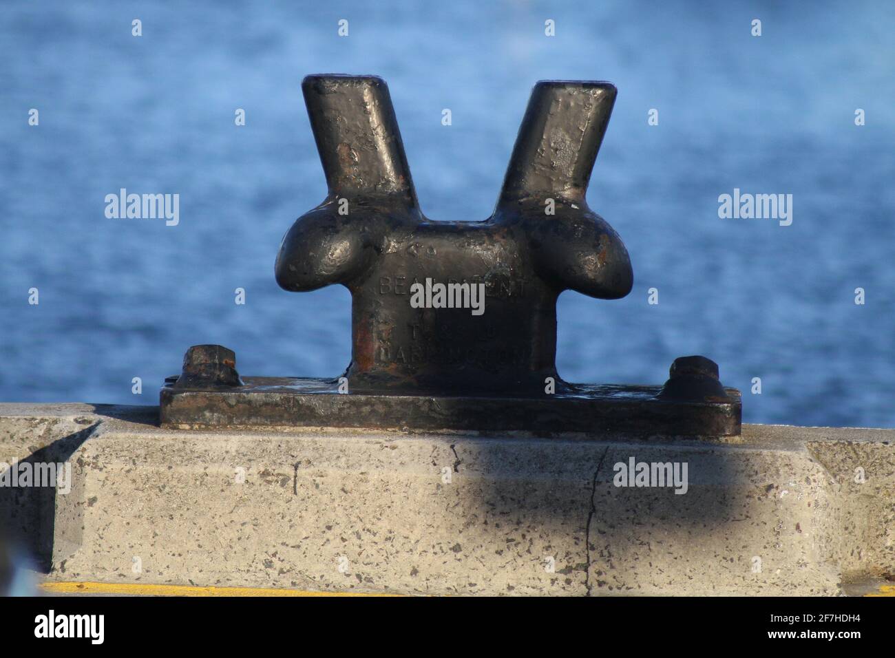 A non occupied metal mooring mast. Sea in the background. Stock Photo
