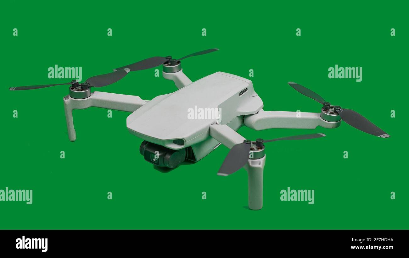 Small modern drone or quadcopter sitting on a green background, isolated.  Little drone, marvel of modern technology Stock Photo - Alamy