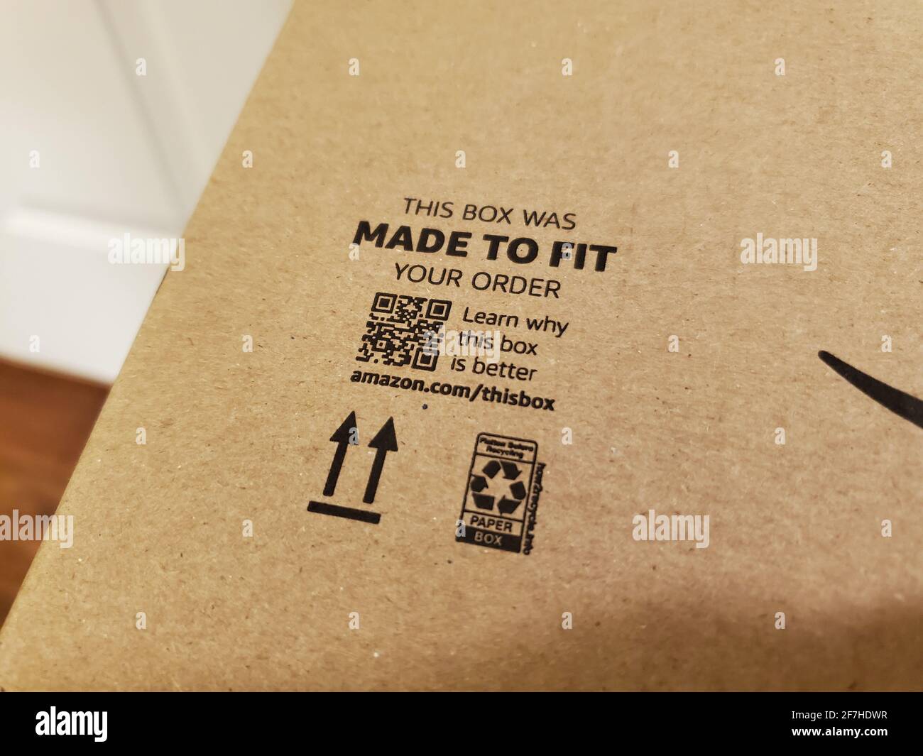 Close-up of sustainability information printed on an Amazon cardboard box,  including a "Made To Fit" label, a QR code, and the international recycling  symbol, photographed in Lafayette, California, February 12, 2021. (Photo