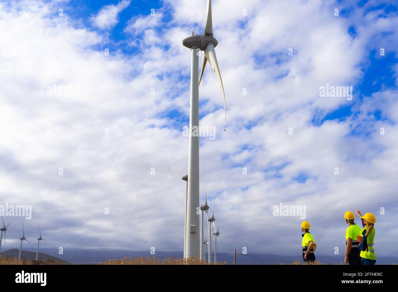 One engineer and skilled workers discussed the plan for the maintenance of wind turbines. Renewable energy with wind generator by alternative energy c Stock Photo