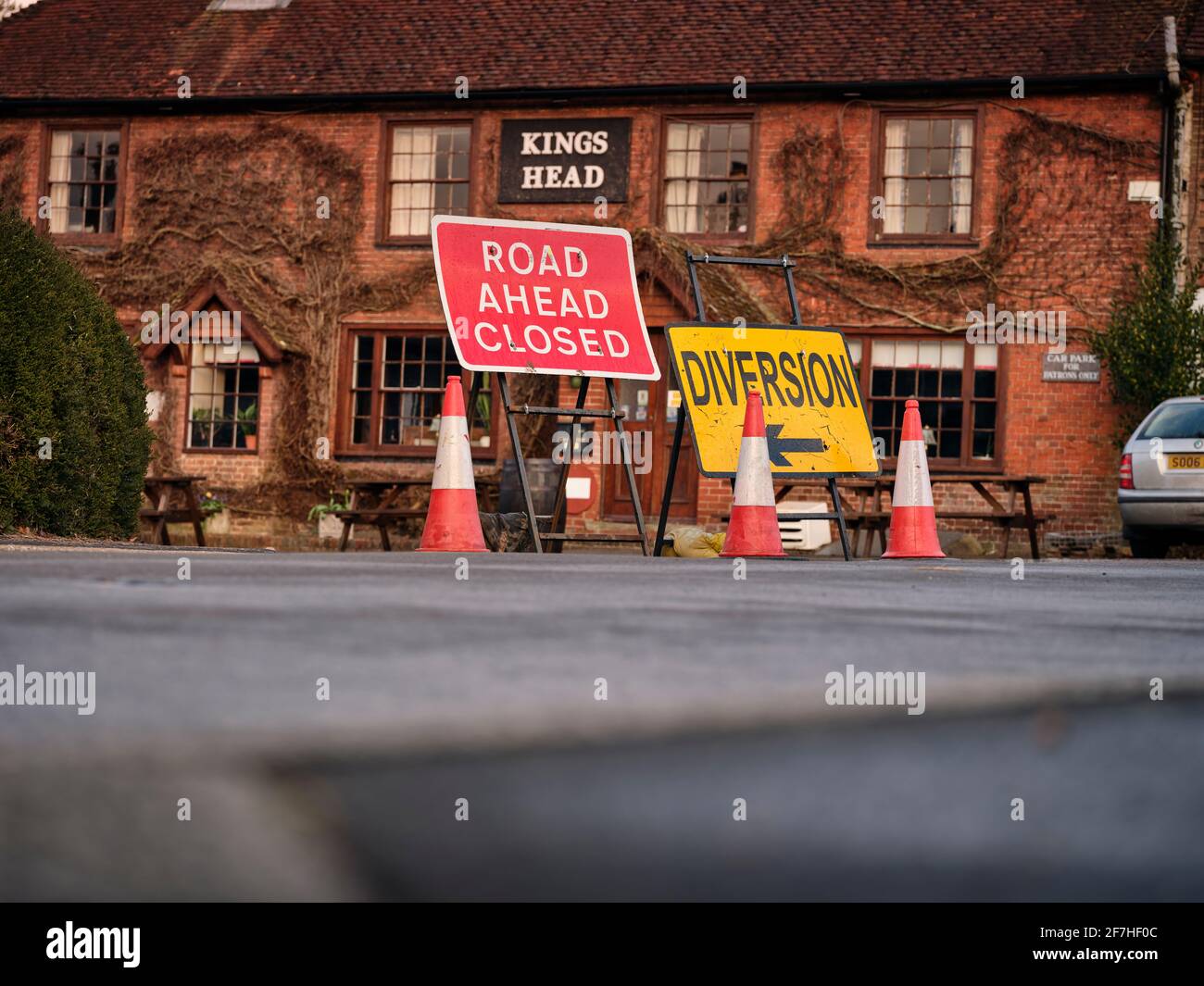 A road closed sign alongside a diversion sign redirecting traffic in East Hoathly, East Sussex, UK Stock Photo