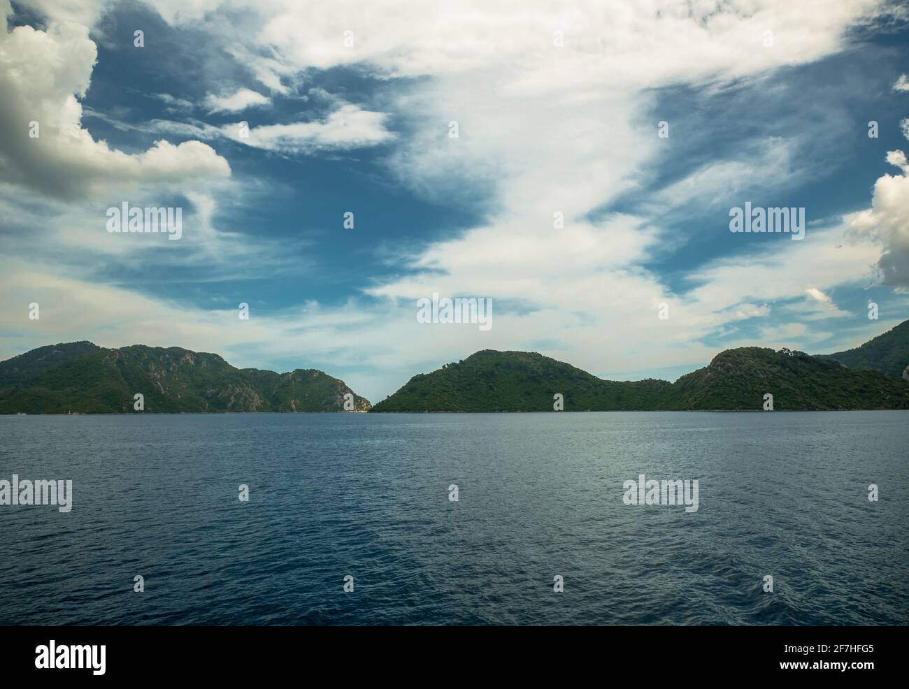 Lagoon in the background of hills and rocks Stock Photo - Alamy