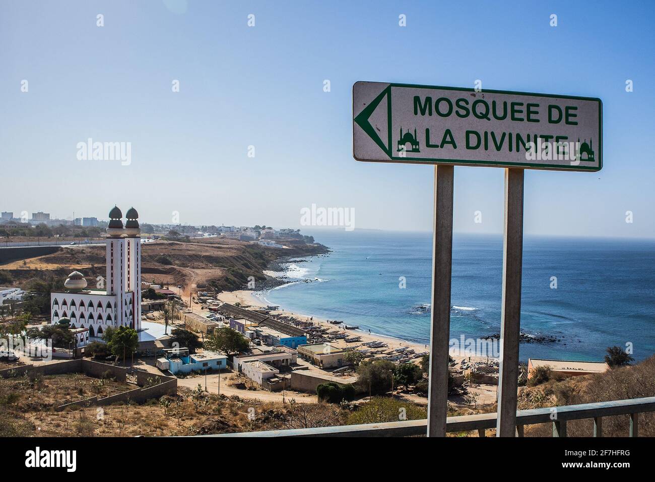 Mosque of divinity or mosquee de la divinite in Dakar, Senegal, behind a signboard leading towards the mosque on a sunny day. City of Dakar in the bac Stock Photo