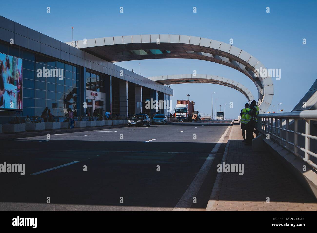 DAKAR, SENEGAL, FEBRUARY 22 2018: Departure platform on the new Blaise Diagne airport in Dakar, Senegal on a sunny day. Some people, security guards a Stock Photo