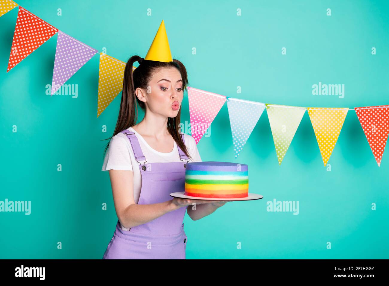 Side profile photo portrait of happy birthday girl wearing cone keeping