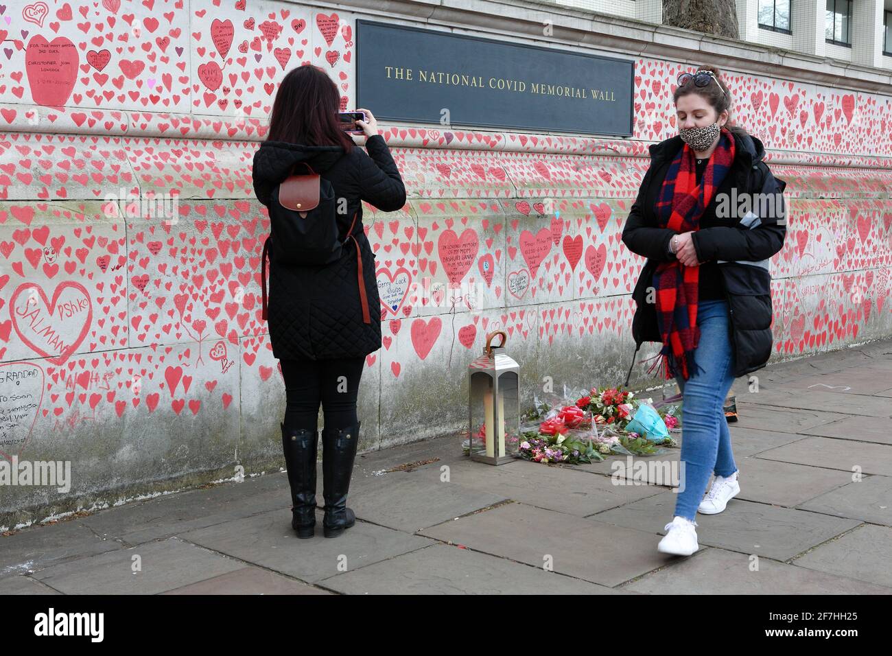 LONDON (UK), April 2021: The memorial wall for the victims of coronavirus facing towards The Houses of Parliament. Stock Photo