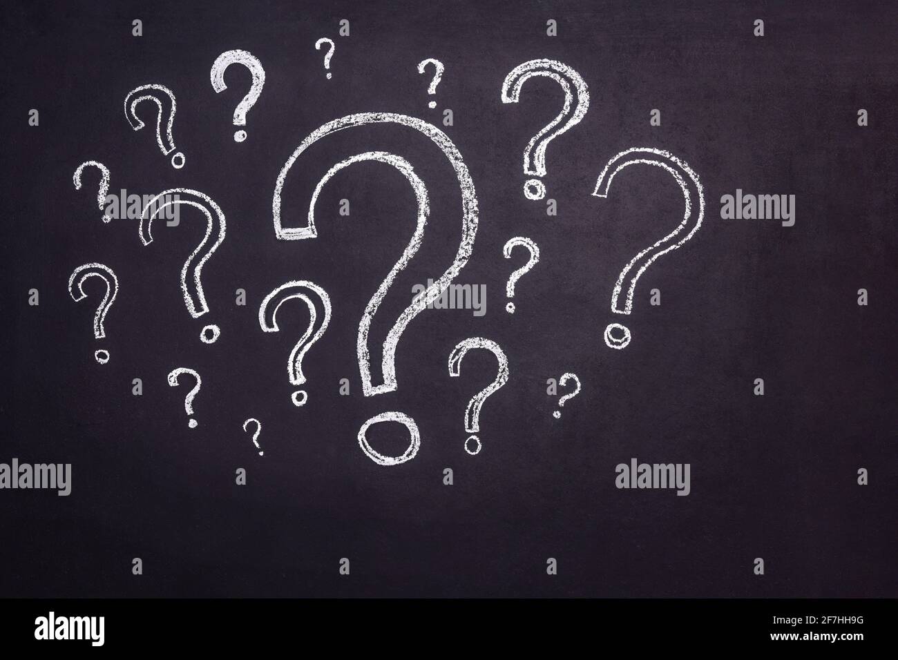 Lots of question marks drawn in chalk on a black chalkboard Stock Photo Alamy