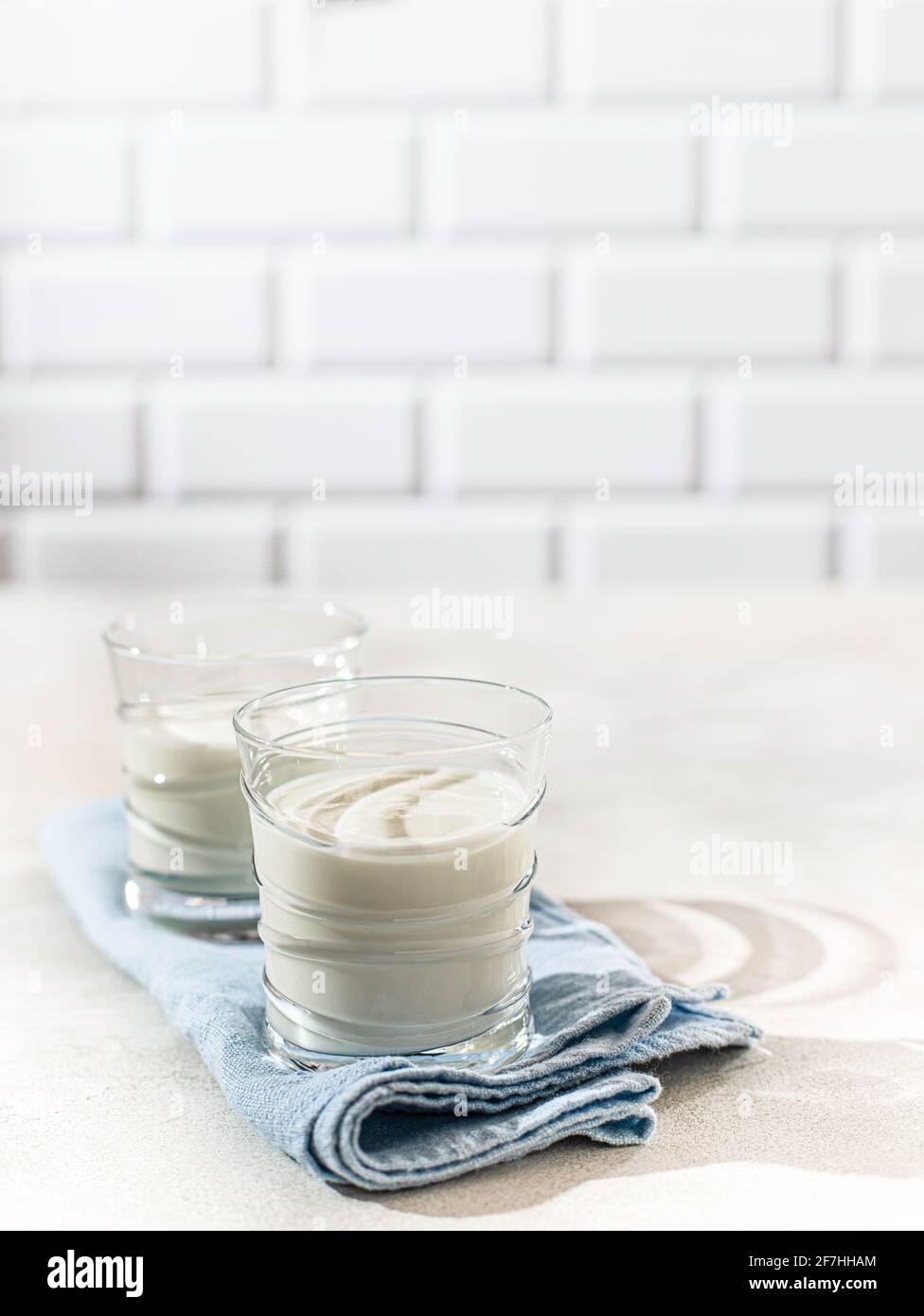 Fermented drink kefir, yogurt in a glass jar on a light background