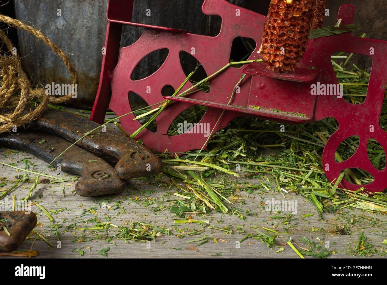 Rusted and worn farm items on hay covered wood floor Stock Photo Alamy