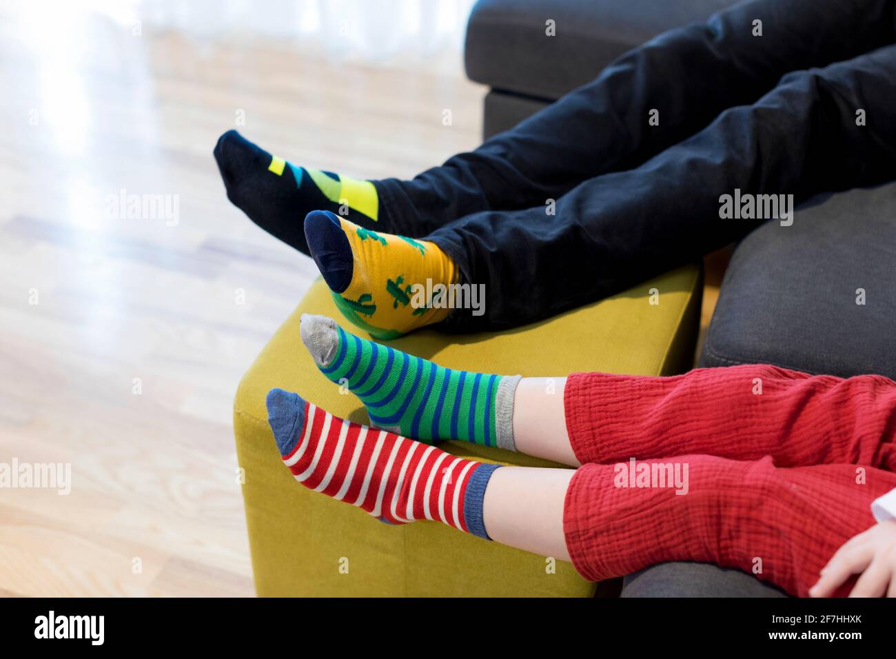 Down syndrome awareness concept. Man with boy wearing different socks