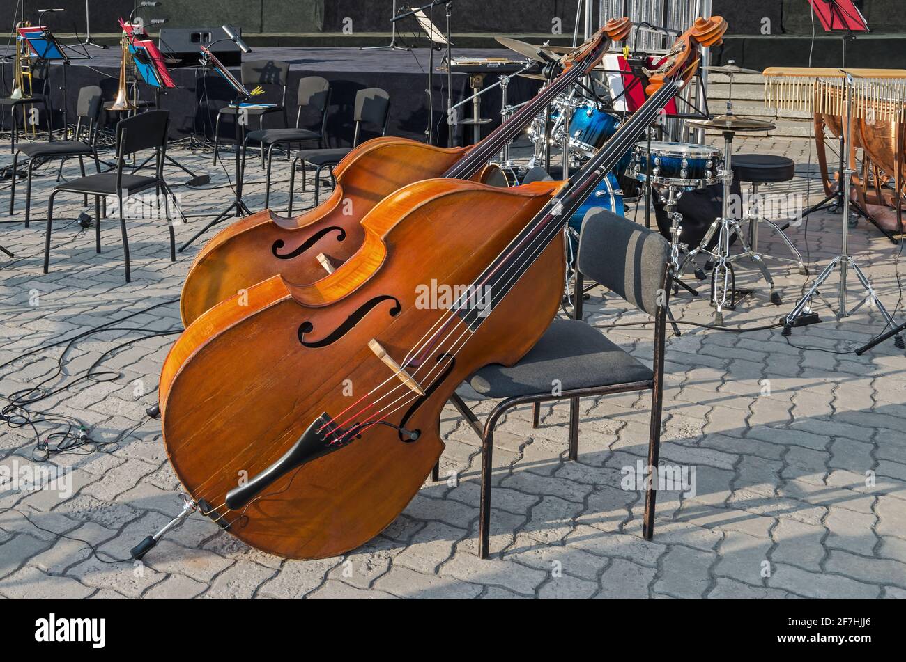Stringed bowed musical instrument double bass on city square in the