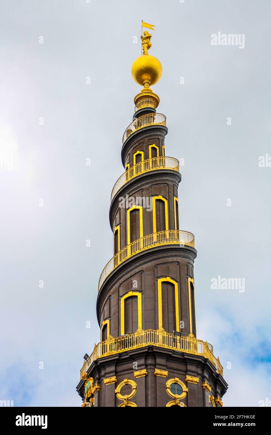 The top of the tower of the Vor Frelsers Kirke, with the characteristic spiral staircase and the golden statue at the top Stock Photo
